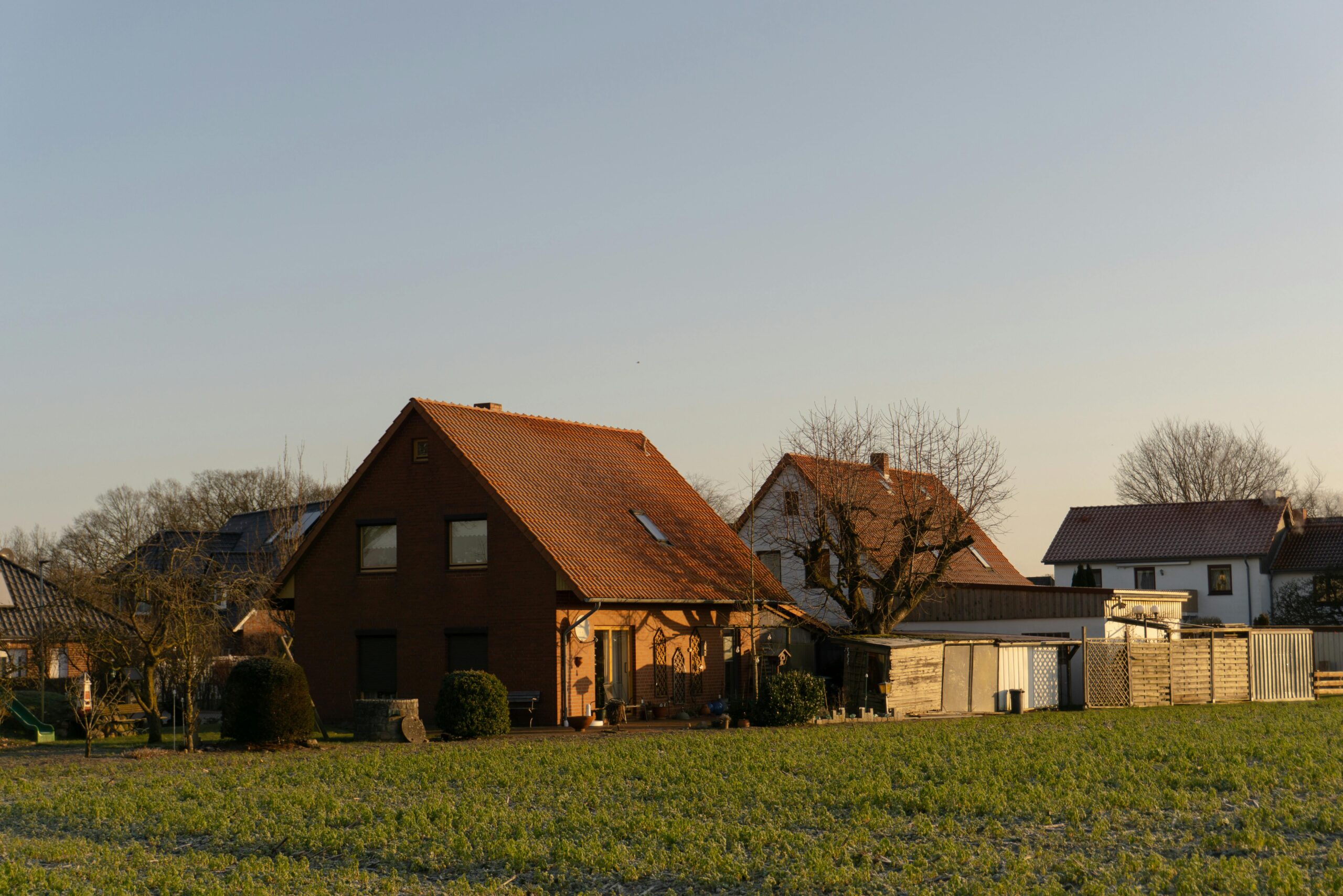 Picturesque rural scene with traditional German houses and lush fields in springtime.